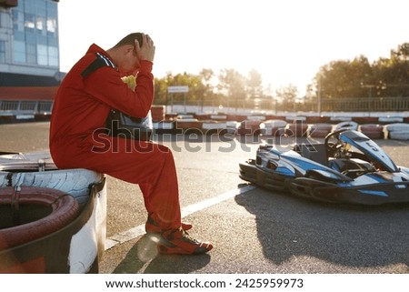 Frustrated go-cart racer in sportswear feeling sad and despair