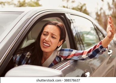 Frustrated Hispanic female driver in a car