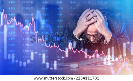 Frustrated investor. Man trader grabs head. Bankrupt businessman. Falling charts near investor. Investor man is upset by fall in value shares. Decline in share price. Losing money on stock exchange