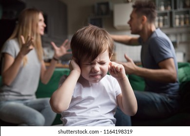 Frustrated Kid Son Puts Fingers In Ears Not Listening To Noisy Parents Arguing, Stressed Preschool Boy Suffering From Mom And Dad Fighting Shouting, Family Conflicts Negative Impact On Child Concept