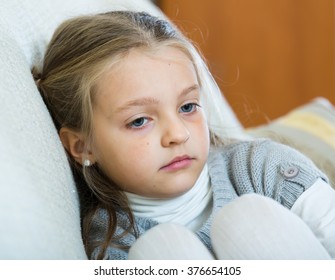 Frustrated little girl with ponytailes bored at home - Shutterstock ID 376654105