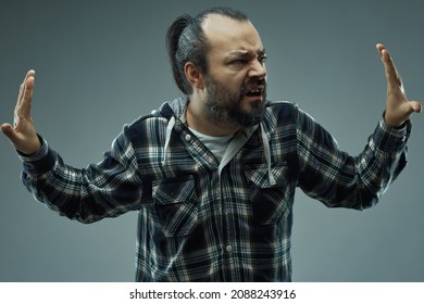 Frustrated man with an anxiety syndrome pushing with his hands to create space for himself in a concept of - All of this is overwhelming and suffocating