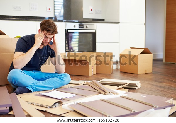 Frustrated\
Man Putting Together Self Assembly\
Furniture