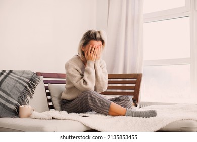 Frustrated Nervous Sad Middle Aged Woman Sitting On Sofa, Touching Forehead, Suffering From Headache Alone At Home. Worried Stressed Adult Female At Home