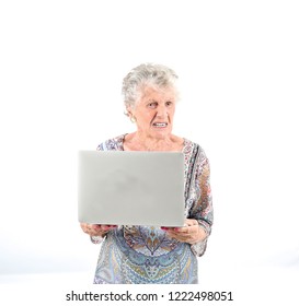 Frustrated Old Woman Holding A Laptop Against A White Background