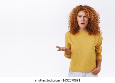 Frustrated, pissed, puzzled serious-looking annoyed redhead curly woman raise one hand in dismay and irritation, frowning outraged, hear insulting words, complain, having argument, white background - Shutterstock ID 1632370891
