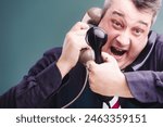 Frustrated professional experiences the chaos of multitasking with telecommunication, shouting while managing multiple phone calls