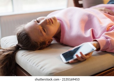 
Frustrated Sad Woman Lying On Couch With With Smartphone,  Bad News, Unhappy Teen Girl Breaking Up With Boyfriend, Unpleasant Phone Conversation, Feeling Pain, Heartbreak