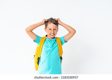 Frustrated Schoolboy Tears His Hair, Standing On White Background Studio With Backpack. Frustration, Depression, Problems With Parenting. Child Does Not Want To Study, The Boy Is Insulted And Bullied