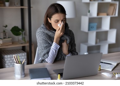 Frustrated sick girl wrapped in scarf suffering from cold, fever, flu, influenza. Ill woman feeling bad, unwell, blowing nose, holding tissue at face. Patient consulting doctor online on video call