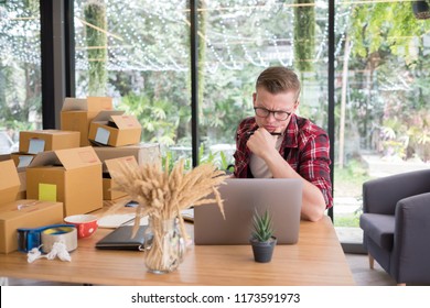 frustrated startup small business owner working at workplace. stressed freelance man seller check product order for delivery to customer.  Online selling, e-commerce, shipping concept
