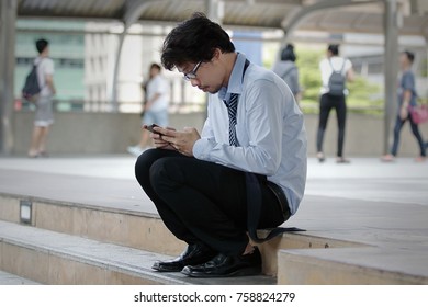 Frustrated stressed young Asian business man feeling strain or tried or disappointed at staircase. - Shutterstock ID 758824279