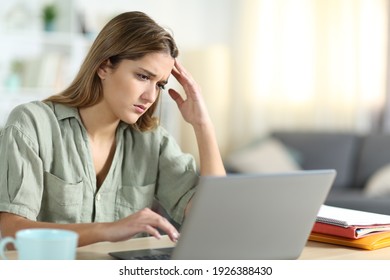 Frustrated Student Reading Bad News Content On Laptop At Home