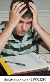 Frustrated Teen Boy High School Student Doing French Foreign Language Homework In A Notebook