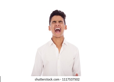 Frustrated Teenager Opens His Mouth Screaming With Closed Eyes, Isolated On A White Background.