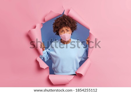 Similar – pink and blue torn strips of paper on a white background