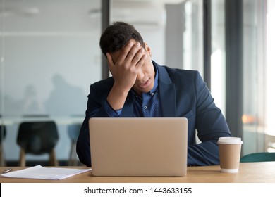 Frustrated upset black business man stressed about computer problem, bad online news financial market crisis, sad desperate african ceo feel loser sit at desk with laptop shocked by bankruptcy debt - Powered by Shutterstock