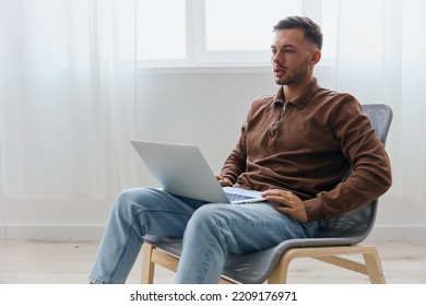 Frustrated Upset Unhappy Tanned Young Man Sitting With Laptop At Home Get Bad Shocked Awful Negative News From Boss Worried About Problem At Work. Bad Financial Report Concept. Copy Space