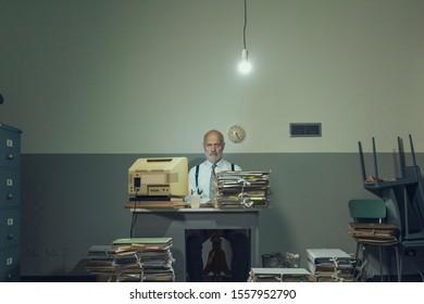 Frustrated vintage style businessman working in a rundown  office, he is overloaded with papework
