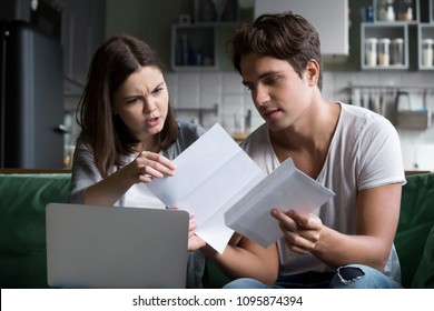 Frustrated Wife Shocked By Bad News, High Taxes, Final Notice Past Due Debt Reading Mail Paper Letter From Bank With Husband At Home, Millennial Couple Angry With Financial Problems, Domestic Bills