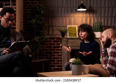 Frustrated Woman Explaining Fight And Relationship Issues To Male Psychologist At Therapy Session. Dealing With Marriage Difficulties And Talking To Professional Counselor In Office.