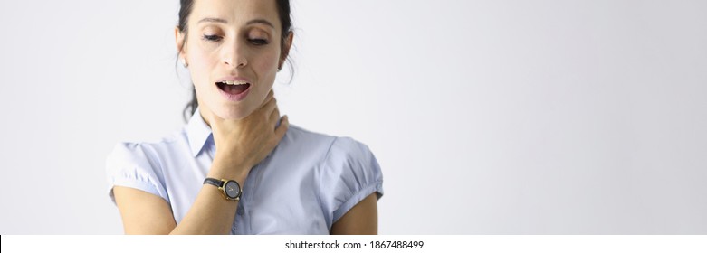 Frustrated Woman Holds Her Throat With Her Hand And Coughs. Respiratory Tract Disease Concept