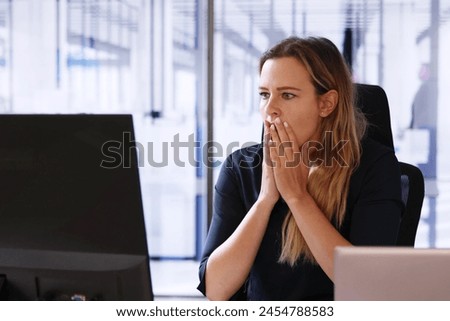 Frustrated worker facing computer hack breach ransomware attack.
