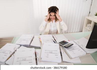 Frustrated Young Accountant Overloaded With Work In Office