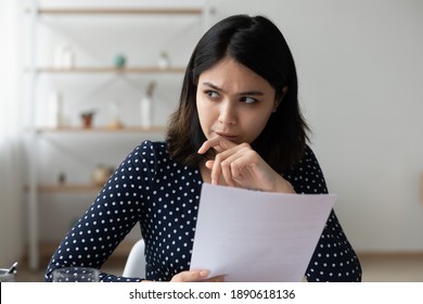 Frustrated Young Asian Ethnicity Woman Holding Paper Bank Debt Notification Thinking Of Financial Problems, Worried Millennial Korean Lady Considering Postal Correspondence Letter Document At Home.