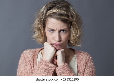 Frustrated Young Blonde Woman Sulking With Fists Under Chin Frowning Eyes In Childish Manner