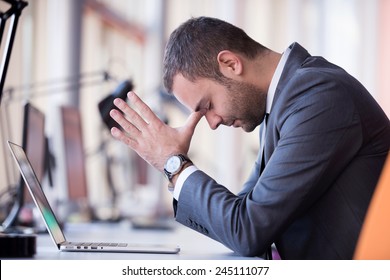 Frustrated Young Business Man Working On Laptop Computer At Office