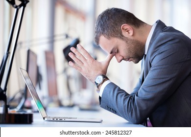 Frustrated Young Business Man Working On Laptop Computer At Office