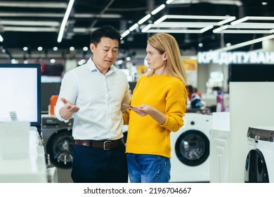 Frustrated Young Diverse Family Of Shoppers, Man And Woman, Not Having Enough Money On Credit Bank Card To Buy Electronic Goods In Supermarket