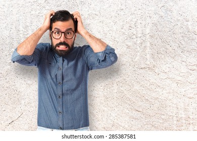 Frustrated Young Hipster Man Over Textured Background 