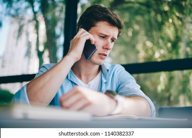 Frustrated Young Man 20 Years Old Unhappy With Bad News Head During Phone Call On Smartphone Device.Upset Hipster Guy Dressed In Casual Wear Talking On Cellular About Solving Problem