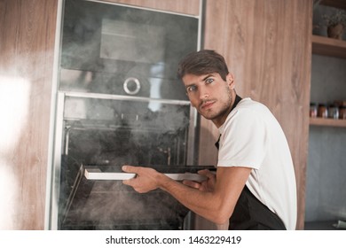 Frustrated Young Man Standing Near Broken Oven