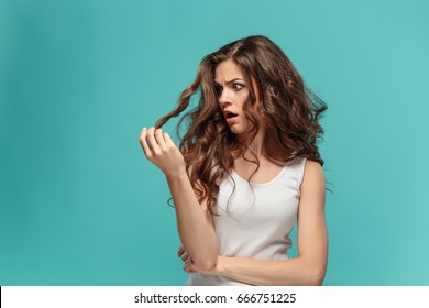 Frustrated Young Woman Having A Bad Hair On Blue