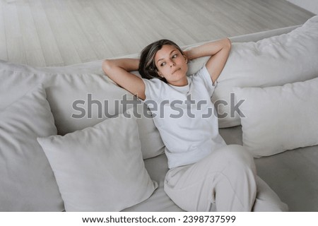 Frustrated young woman n casual sitting on couch in disappointed mood, feels apathy. Lonely American girl exhausted, emptiness. Foto stock © 