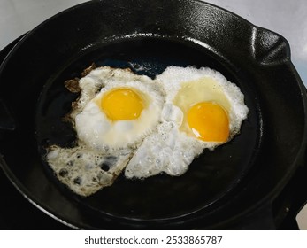 Fry the eggs incast iron pan,on the stove,homemade cooking style. - Powered by Shutterstock