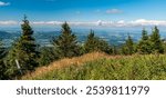 Frydek-Mistek, Ostrava and Havirov cities with rural landscape around from Lysa hora hill summit in Moravskoslezske Beskydy mountains in Czech republic during summer day with blue sky and clouds