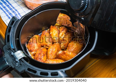 Frying BBQ chicken wings in a hot air fryer.
