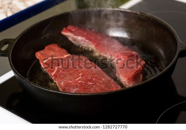 Frying Beef Steaks On Cast Iron Stock Photo Edit Now 1282727770