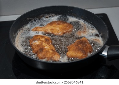 Frying chicken cutlets in a pan.
