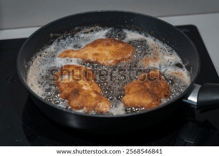 Frying chicken cutlets in a pan.