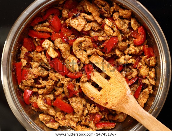 Frying Chicken and Pepper. Series - making\
tortilla with chicken and bell\
pepper.