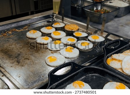 Frying Eggs at Hotel Breakfast Buffet