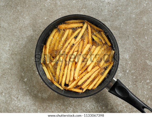 frying french\
fries in a pan with oil, top\
view