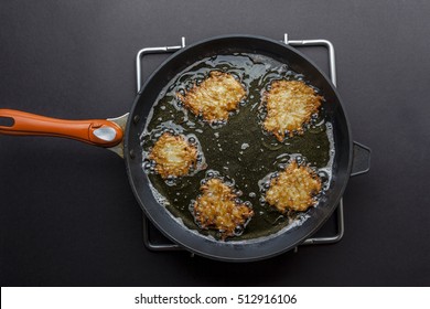 Frying Latkes With Ready Side Up In Deep Oil On The Pan From Above