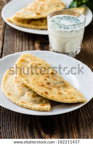 Similar – Image, Stock Photo Baked Cheburek with Sour Cream-Garlic Sauce on Tray