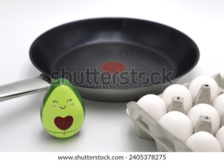 Frying pan eggs and kitchen timer for quick fast and easy meal cooking meals at home background